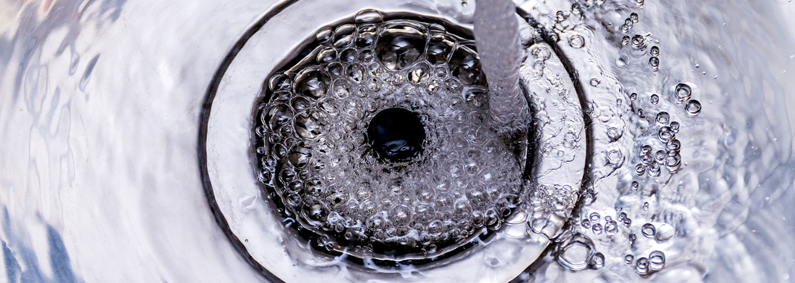 a sink drain filling with water